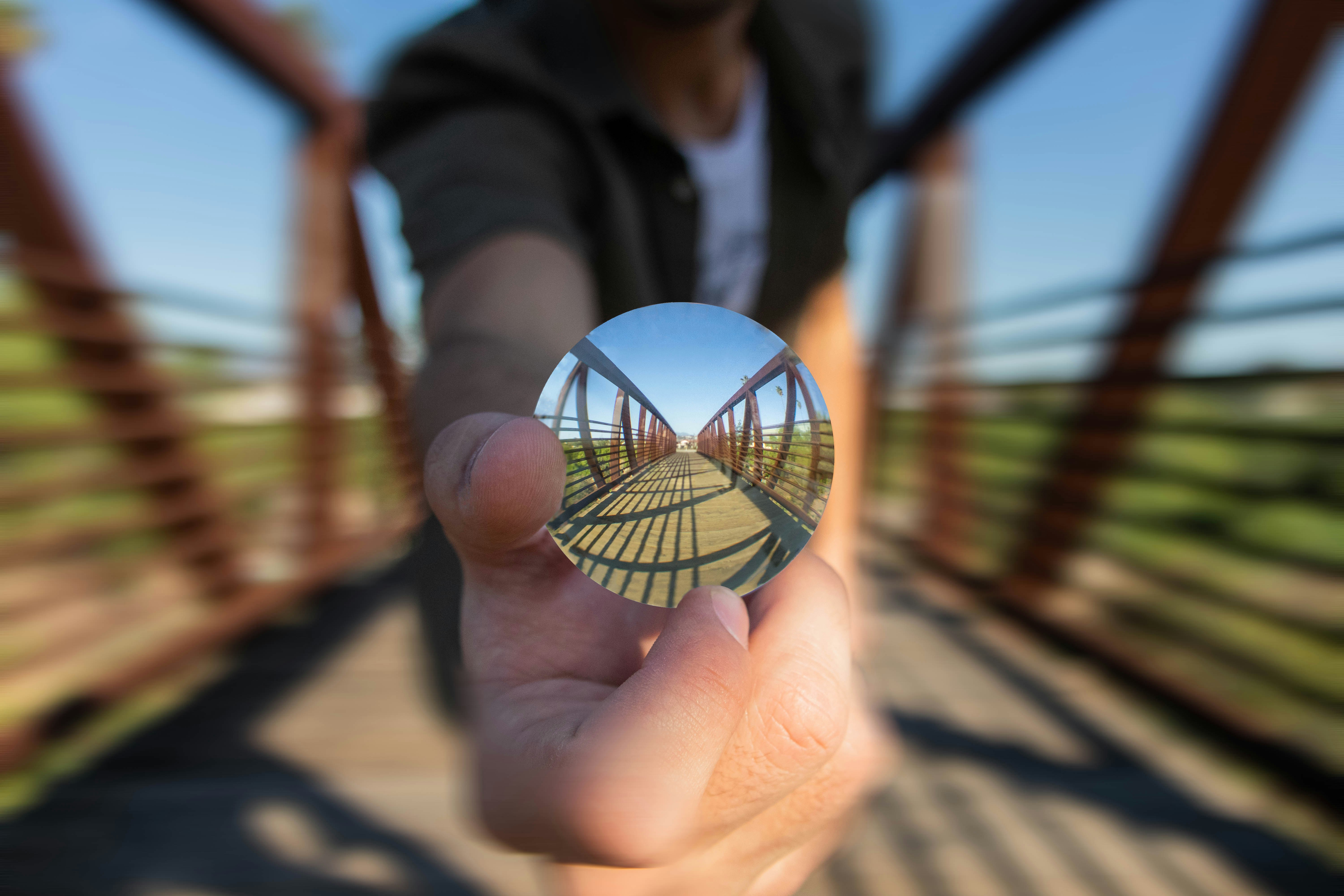 selective focus photography of person standing on bridge